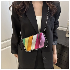 Detailed view of a rainbow striped crossbody bag with silver studs and chain strap