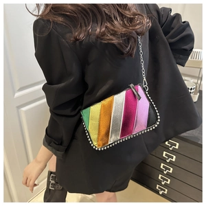 Macro view of a colorful rainbow striped crossbody bag with silver bead trim details