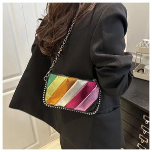 Rainbow striped crossbody bag with silver metallic chain and rivet detail worn by model