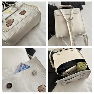 Detail view of marble texture, bear embroidery, and interior capacity of this beige backpack
