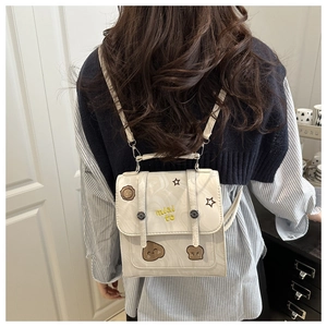 Close-up of vintage mini white marble backpack with cute patches and miai to embroidery