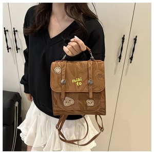 Detail of vintage brown marbled backpack with cute star embroidery and metal buckle