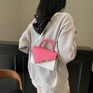 Fashionable pink and white color-block handbag with woven handle and gold clasp lock