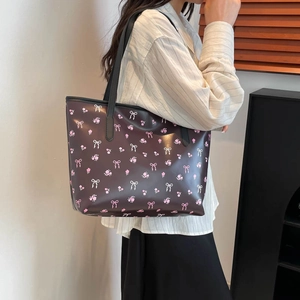 Sac cabas marron foncé avec imprimé floral porté à l'épaule, vue de profil sur mannequin