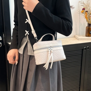 Chic white woven mini bucket bag with silver dual zippers and detachable shoulder strap