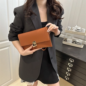 Brown Epi texture envelope clutch with gold geometric buckle for elegant dinner parties