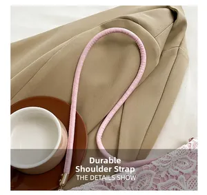 Detailed view of pink leather replacement shoulder strap with durable stitching and metal clip
