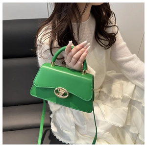 Detailed view of a lime green crossbody bag worn by a model in a social setting