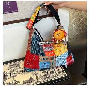 Detailed view of colorful patchwork tote bag with elk prints and plush burger charm accessory