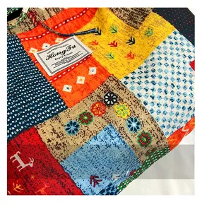 Close-up of vibrant patchwork fabric tote bag showing detailed floral patterns and stitching