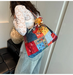 Detail of multi-color patchwork canvas tote bag with a cute burger plush keychain accessory