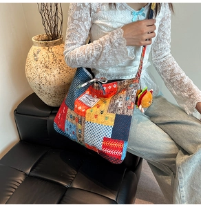 Detailed view of colorful bohemian patchwork canvas crossbody bag with burger charm