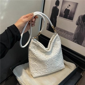 Elegant white floral lace shoulder bag with golden hardware and cylindrical handle