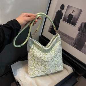 Elegant mint green lace hobo bag with floral patterns and gold hardware handle