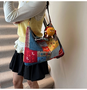 Detail of colorful patchwork canvas tote bag featuring a cute hamburger plush charm