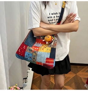 Detailed close-up of a patchwork canvas tote bag with a floral pattern and burger charm