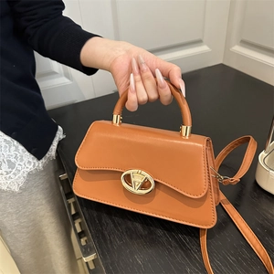 Elegant tan leather square tote bag with gold metal buckle and detachable shoulder strap