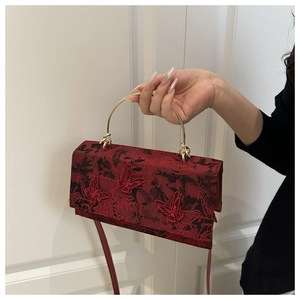 Detailed embroidery with 3D butterflies and lace on a vintage burgundy crossbody bag
