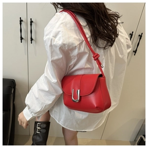 Red leather shoulder bag with silver U-shaped clasp and knotted strap detail