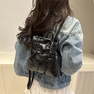 Chic black ballet-style pleated backpack with bow details and drawstring closure