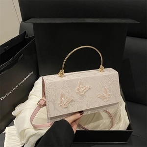 Elegant vintage lace handbag with butterfly embroidery and golden circular handle in a gift box