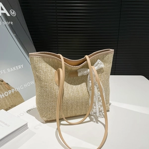 Minimalist summer straw tote bag with faux leather straps and white lace bow detail