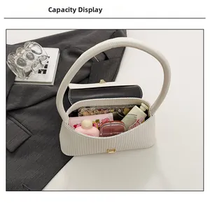 Detailed view of white textured shoulder bag showing spacious interior capacity and storage