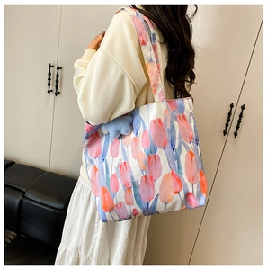 Side view of large floral canvas tote bag showing tulip print and carrying capacity