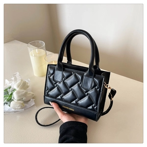 Detail of black quilted leather bag with stitched patterns and Fashion & Bags text logo