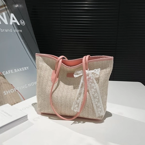 Summer woven straw tote bag with pink leather handles and delicate lace bow accent