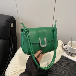 Minimalist green crossbody bag with silver U-shaped buckle and knotted leather strap