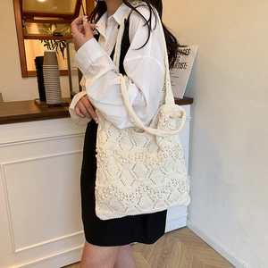 Chic cream knit tote bag with pearl accents and hollow weave for casual commute