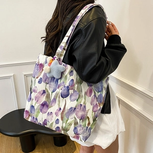 Floral canvas tote bag with purple tulip patterns and star plush charm on female model