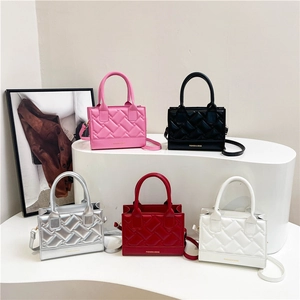Chic quilted square crossbody bags in five colors displayed on minimalist white stairs