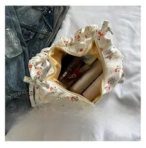 Detail view showing large internal capacity of floral canvas tote bag with cosmetics