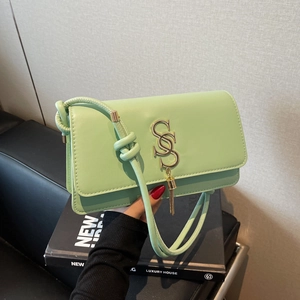 Mint green square crossbody bag with gold tassel and S-shaped logo in retro style