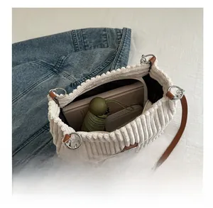 Detail view of large corduroy tote bag showing interior space with daily essentials