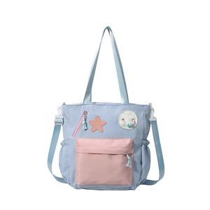 Spacious blue and pink school tote bag with star patch and adjustable shoulder straps