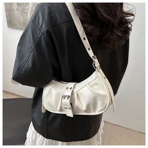 Close-up of white ruched crescent bag with silver buckle and adjustable shoulder strap