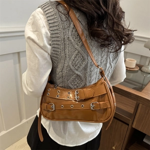 Brown vintage Y2K rivet shoulder bag with metallic eyelets and glossy PU finish
