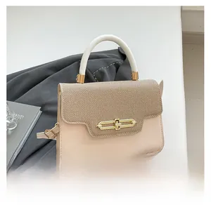 Detailed view of chic beige leather handbag with khaki woven flap and gold metal clasp