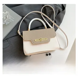 Detail view of contrast vintage crossbody bag with metal lock and phone size comparison