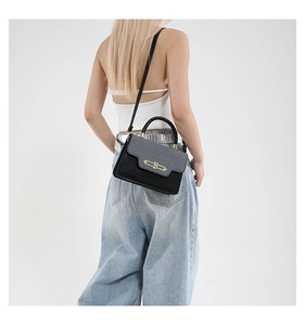 Model view showing the scale of the two-tone gray and black small square crossbody bag