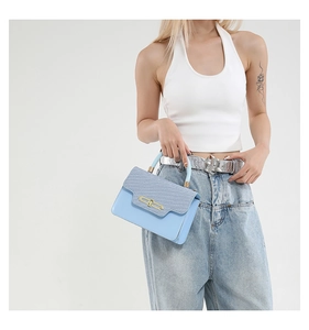 Fashionable light blue handbag with woven texture flap and golden buckle on model