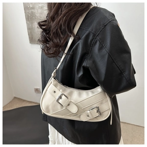 Model wearing a white Y2K baguette bag with dual silver buckles and glossy PU finish