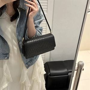 Minimalist black woven shoulder bag for women with elegant golden metal buckles