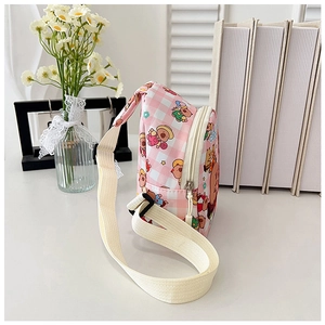 Detail of pink gingham kids crossbody bag with cute cartoon bear prints and strap