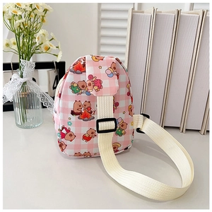 Detail of pink plaid kids crossbody bag featuring cute cartoon bear prints and nylon strap