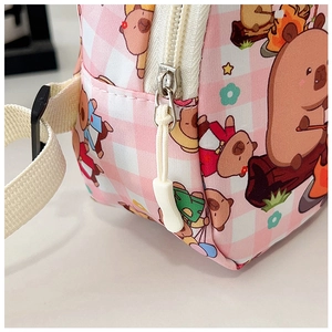 Detail of pink plaid Capybara bag showing secure zipper and adjustable strap buckle