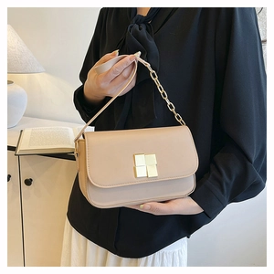 Detail of beige flap shoulder bag with gold square buckle and leather chain strap